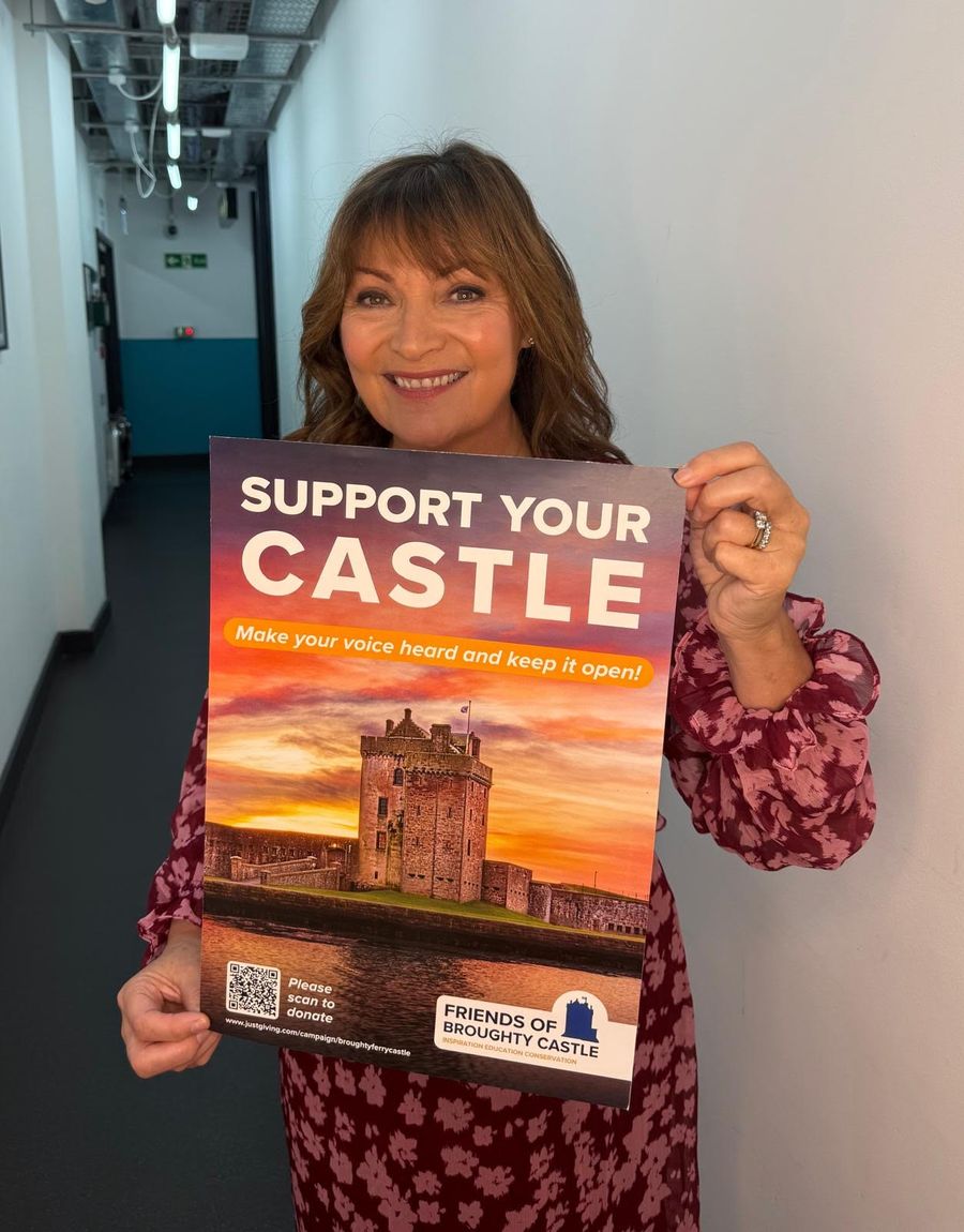 Lorraine Kelly holding a Support Your Castle poster