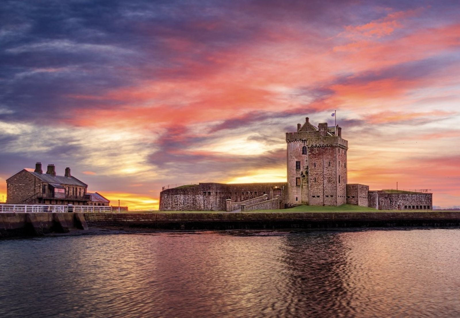 Broughty Castle against a blazing sunset, reflected in the Tay